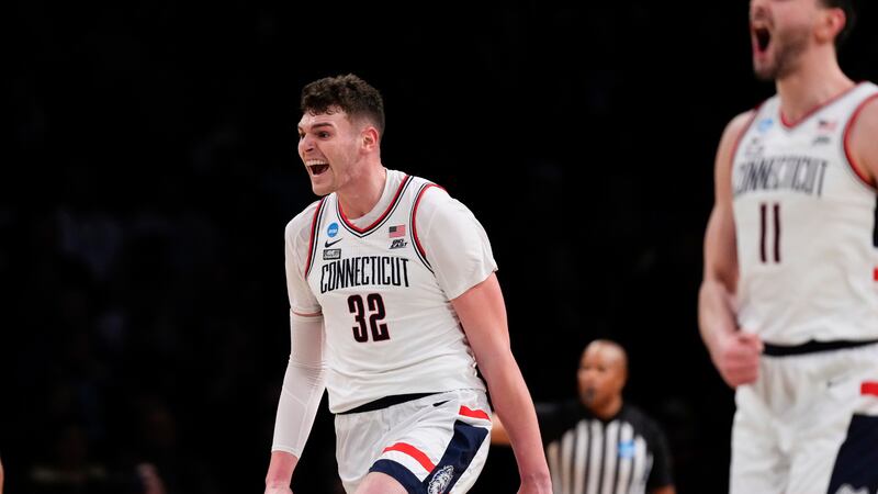 FILE PHOTO: UConn's Donovan Clingan (32) celebrates with teammates during the first half of a...