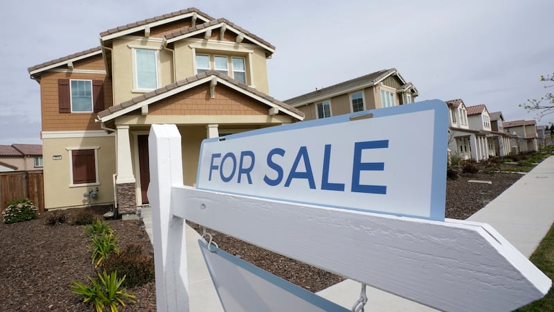 FILE - A "for sale" sign is posted in front of a home in Sacramento, Calif., March 3, 2022.