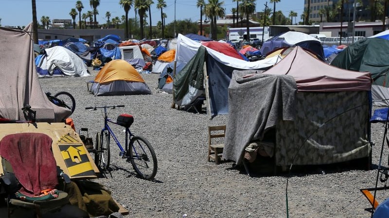 In this Wednesday, Aug. 5, 2020, file photo, a large homeless encampment is shown in Phoenix....