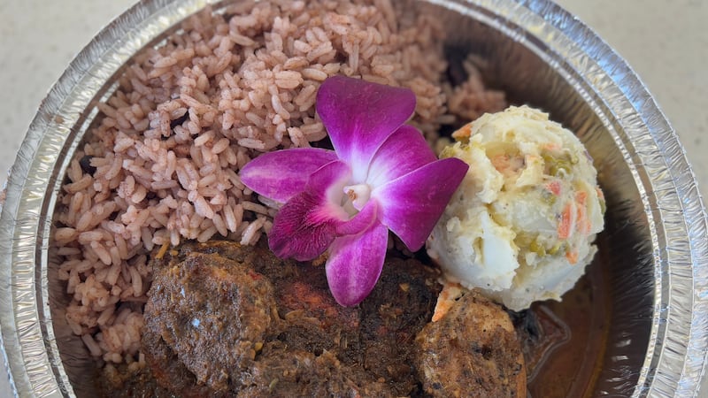 Jerk Seafood Combo Entree (salmon and shrimp) served with rice and peas. Potato salad...